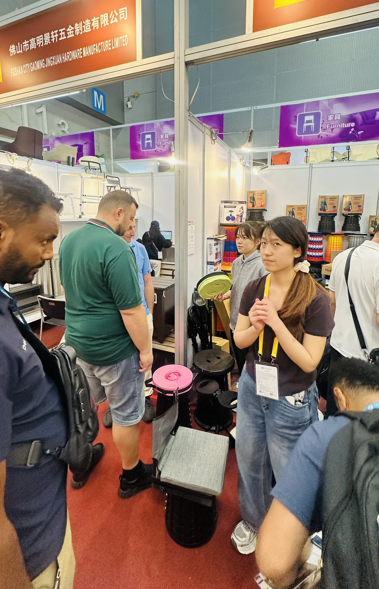 International buyer examining Locyop collapsible stool at Canton Fair booth