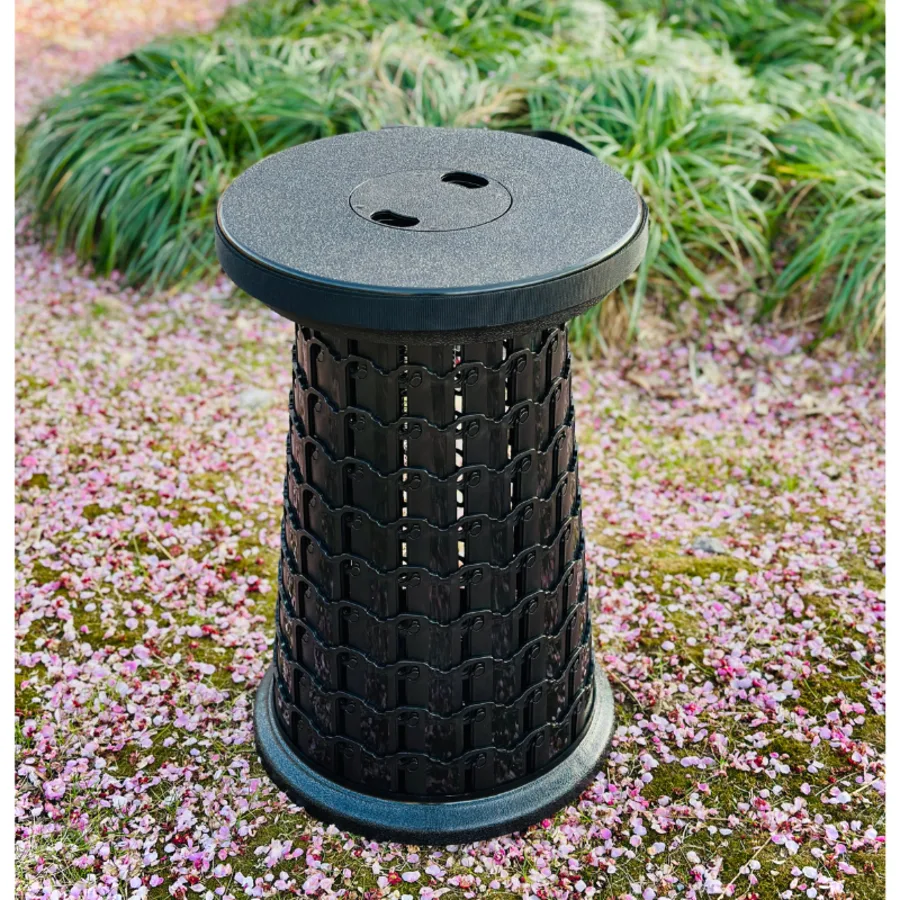 Collapsible Stool 12.0 1000lb telescopic stool in park with cherry blossom petals - factory direct wholesale from Yiwu China